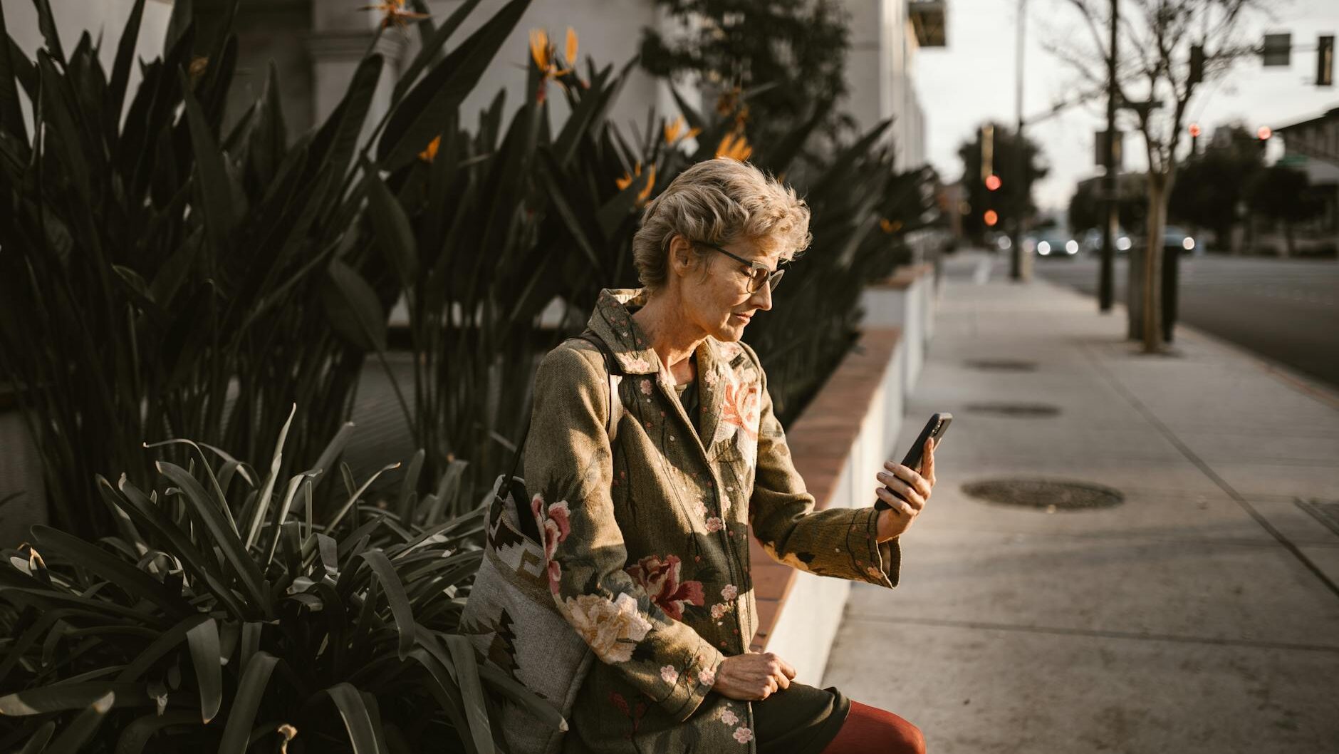 woman in brown and black jacket sitting on red chair